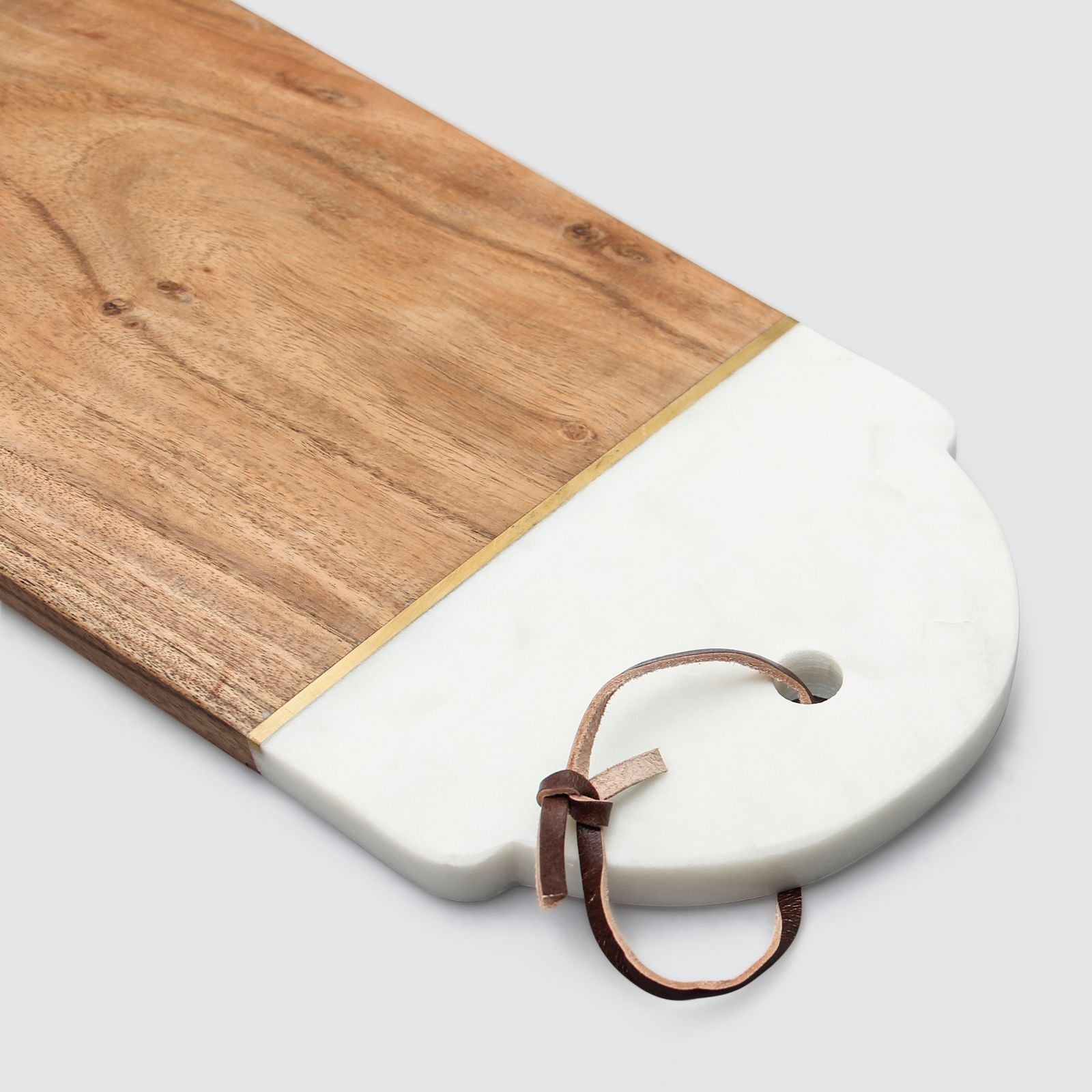 Wood Cutting board showing detail of marble and leather handle.