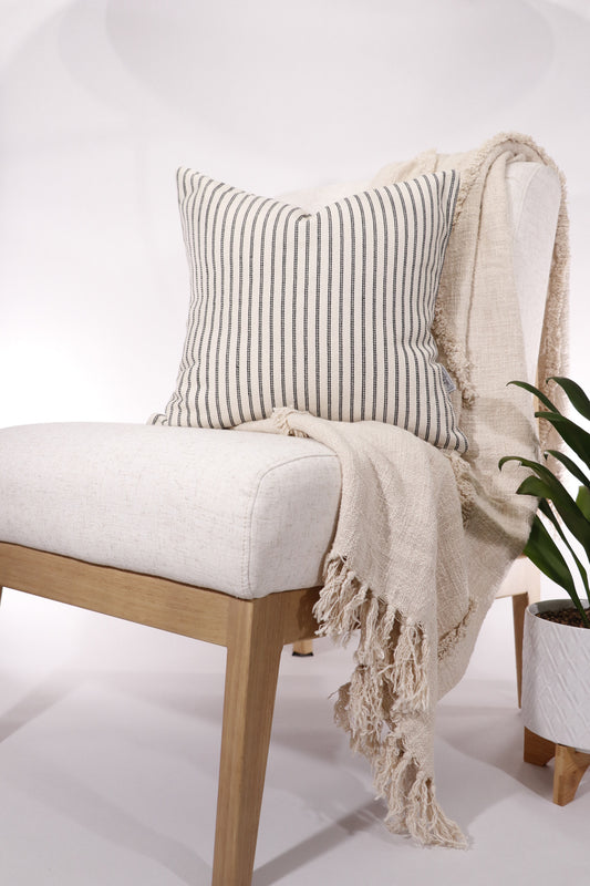 Black and ivory stripe 18x18 pillow cover displayed on a chair.