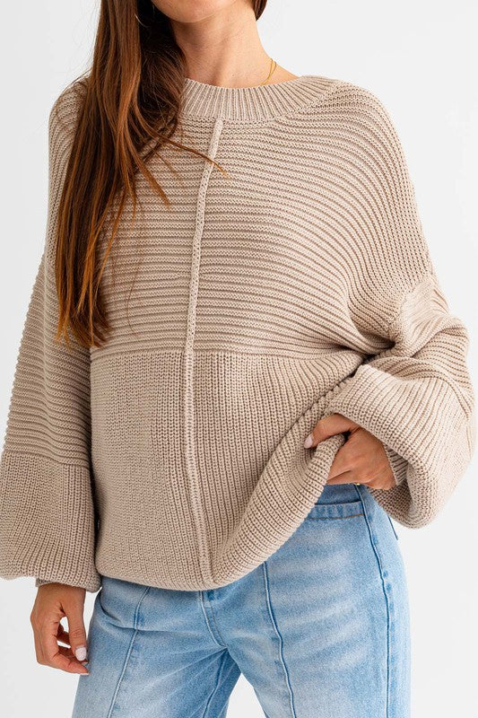 Beige knit sweater with balloon sleeve.