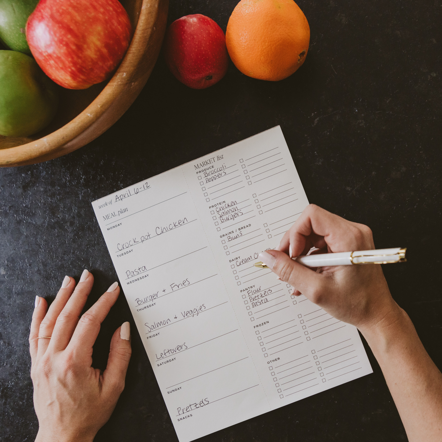 Person Writing On Weekly Meal Planner Notep.ad