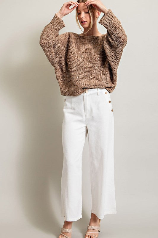 Model wearing loose fit knit top.